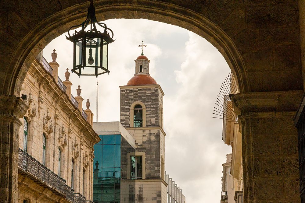 Cuba, Havana. Looking out through archways from the Plaza de Armas. Unesco World Heritage Site.